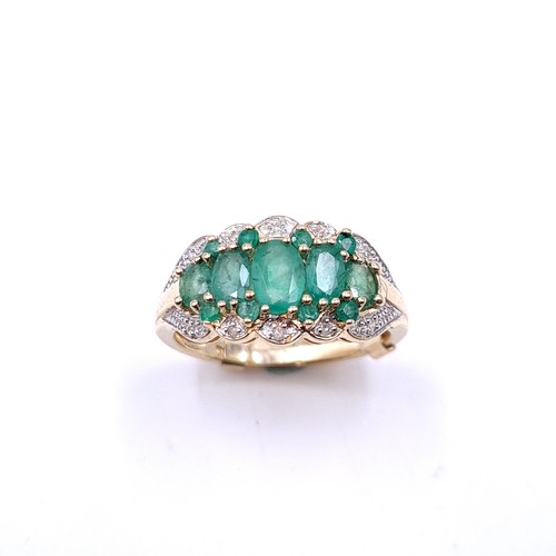 35 - Star Lot : A stunning five gemstone emerald ring with diamonds in 9ct gold . Ring size - P. Weight -... 