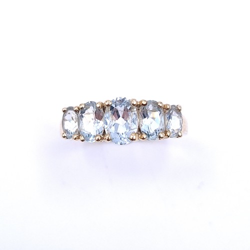 36 - Star Lot : A beautiful five stone graduated aquamarine ring set in nine carat gold. Ring size - O 1/... 