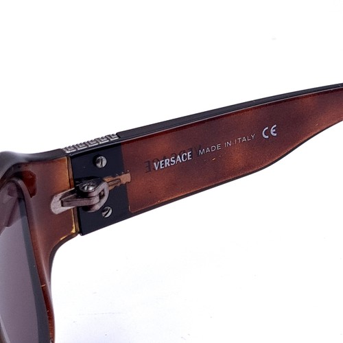 513 - A pair of faux tortoise shell Versace 'Made in Italy' sunglasses.