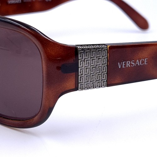 513 - A pair of faux tortoise shell Versace 'Made in Italy' sunglasses.