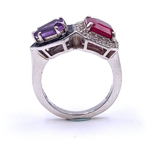 553 - An unusual ruby & amethyst stone ring with white sapphire mount set in sterling silver. Size - M. We... 