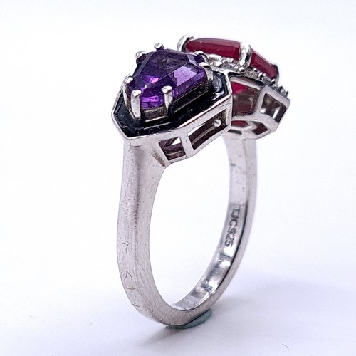 553 - An unusual ruby & amethyst stone ring with white sapphire mount set in sterling silver. Size - M. We... 