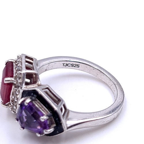 553 - An unusual ruby & amethyst stone ring with white sapphire mount set in sterling silver. Size - M. We... 