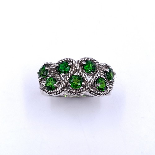 554 - A most attractive seven stone diopside ring with interlace mount set in sterling silver. Size - P. W... 