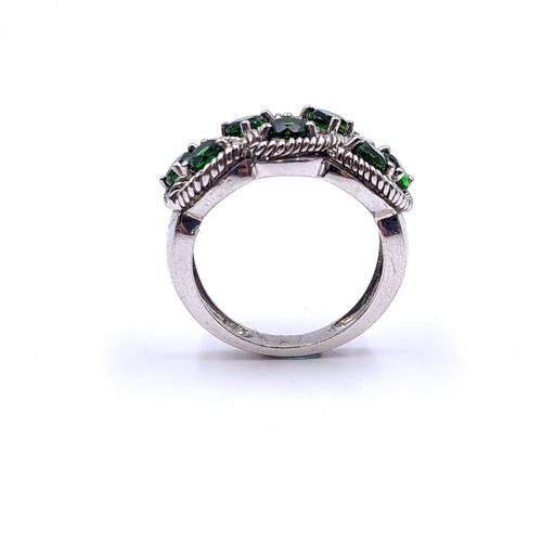 554 - A most attractive seven stone diopside ring with interlace mount set in sterling silver. Size - P. W... 