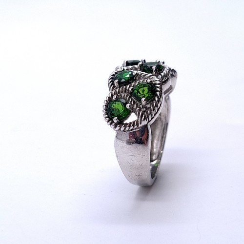 554 - A most attractive seven stone diopside ring with interlace mount set in sterling silver. Size - P. W... 