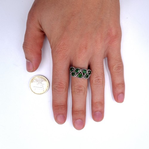 554 - A most attractive seven stone diopside ring with interlace mount set in sterling silver. Size - P. W... 