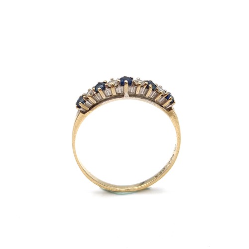 1117 - Star Lot : A pretty five stone sapphire ring with diamonds set in nine carat gold. Ring size: R. Wei... 