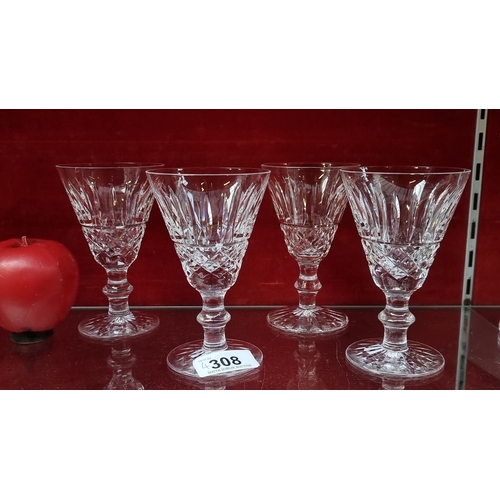 Set of four Waterford crystal wine glasses with intricate cut designs, renowned for their clarity and brilliance. Signed by Waterford.