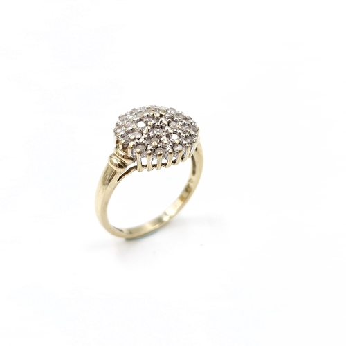 1 - Star Lot : A nine carat gold diamond cluster ring. Est. weight of diamonds - 0.40 carats. Size - N. ... 