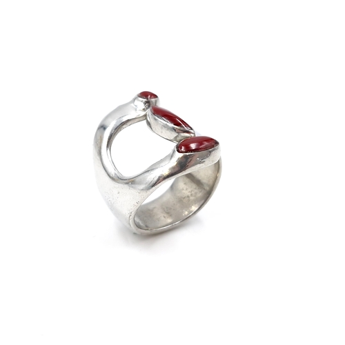 10 - A modernist large heavy silver ring mounted in coral. Size - V. Weight - 13.4 grams.