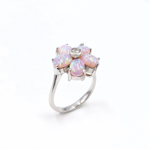 12 - A sterling silver daisy style opal ring with gemstone setting. Size - N 1/2. Weight - 5.6 grams.