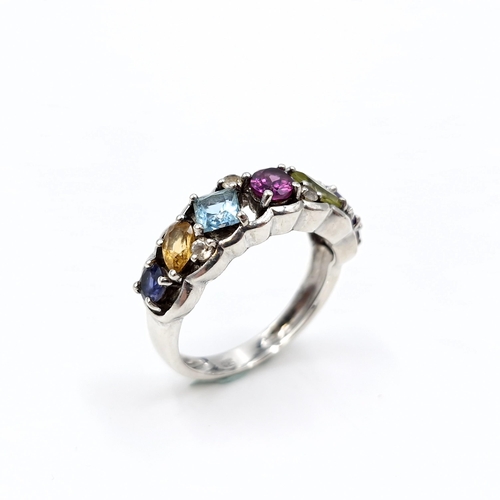 13 - A vari hue gemstone ring, with amethyst, aqua, citrine, sapphire etc  set in sterling silver. Ring s... 