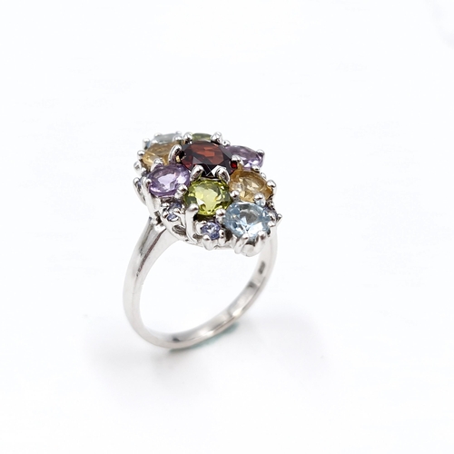 14 - A sterling silver multi stone ring set with garnet, peridot, citrine, amethyst & aquamarine stones. ... 