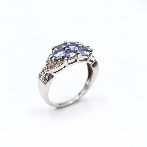 15 - A lovely multi stone tanzanite ring set in sterling silver. Size - Q. Weight - 4 grams.