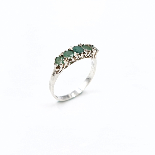 16 - A lovely five stone emerald ring set in sterling silver. Size - K. Weight - 1.6 grams.