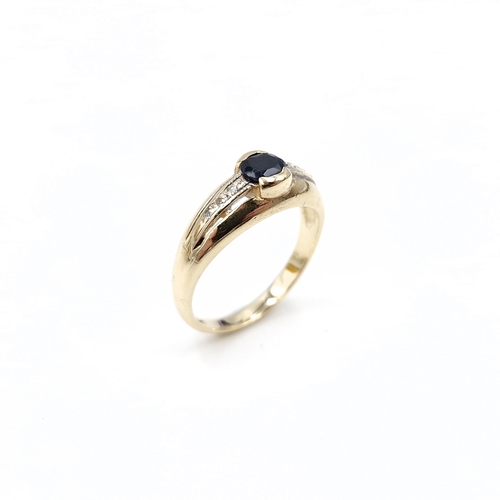 3 - A nine carat gold sapphire stone ring with diamond set shoulders. Size - N. Weight - 2.79 grams.