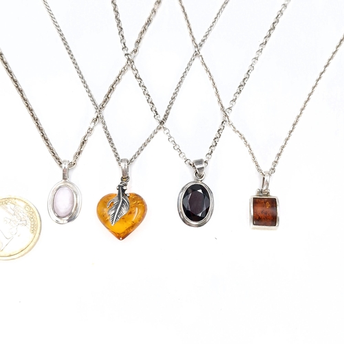 38 - A collection of four necklaces - Two amber together with two further stone examples. Length of chain... 