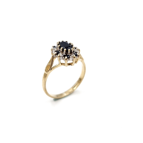 6 - A nine carat gold diamond and sapphire ring. Size - L. Weight - 2.14 grams.