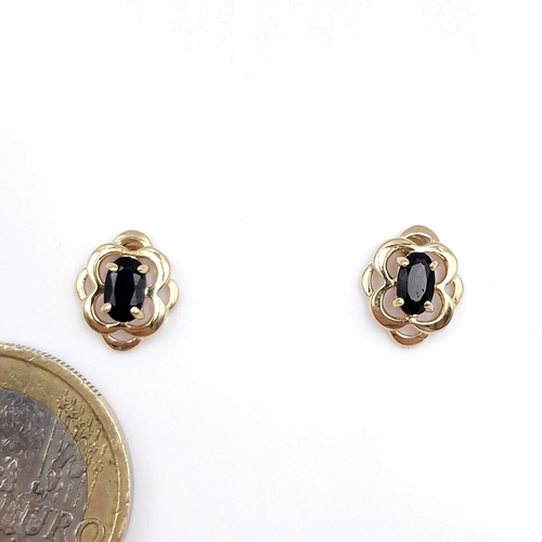 8 - A pair of nine carat gold sapphire stud earrings. Weight - 0.99 grams. Boxed.