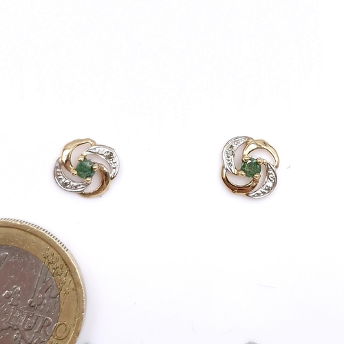 9 - Star Lot : A pair of twist set nine carat gold emerald and diamond stud earrings. Weight - 0.98 gram... 