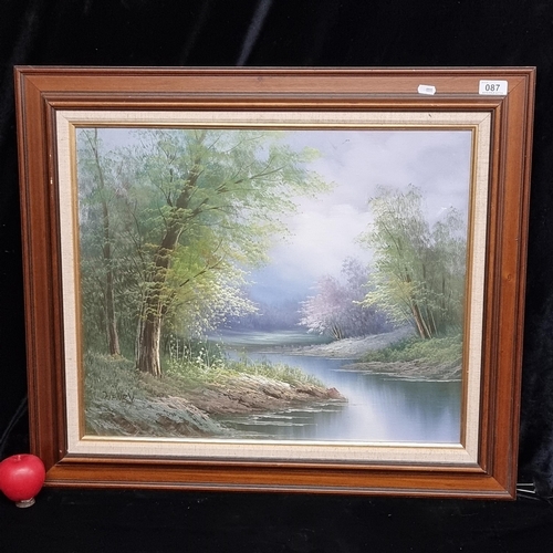 87 - A large original oil on board painting. Features a serene landscape with lush green grassland with l... 