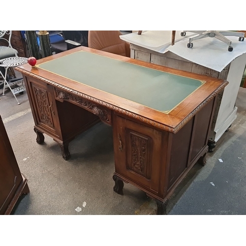 1004 - Star Lot : Antique carved oak desk, featuring intricate detailing, with a green tooled leather writi... 