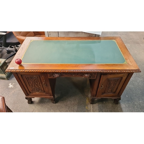 1004 - Star Lot : Antique carved oak desk, featuring intricate detailing, with a green tooled leather writi... 