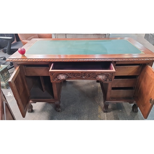 1004 - Star Lot : Antique carved oak desk, featuring intricate detailing, with a green tooled leather writi... 