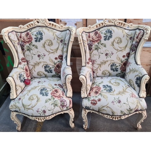 996 - Star Lot : A beautiful Pair of floral upholstered wingback armchairs with carved wood frames, displa... 