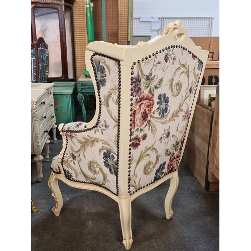 996 - Star Lot : A beautiful Pair of floral upholstered wingback armchairs with carved wood frames, displa... 