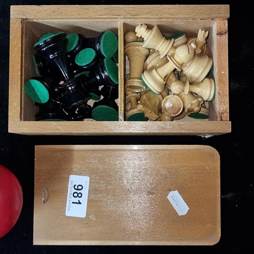 981 - A lovely set of carved wooden chess pieces housed in a neat wooden box with sliding lid.