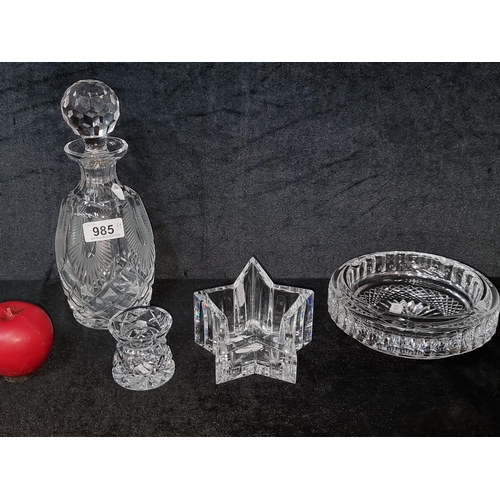 985 - A set of four Waterford Crystal pieces features a decanter with original stopper, a star shaped voti... 