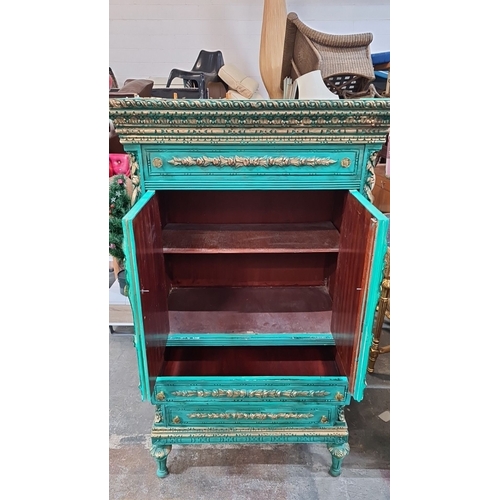 1198 - Star lot : A French Chateau Neoclassical-style turquoise armoire with gilded floral details, double ... 