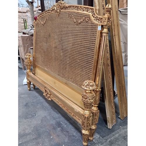 1204 - Star lot ; a Beautiful Gilded wood and wicker bed , intricately carved with floral motifs, reflectin... 