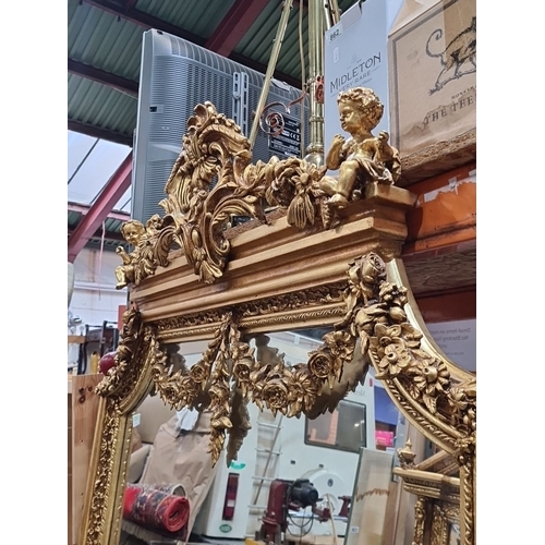 1206 - Super Star lot : A large Gilded Baroque-style mirror with intricate floral and cherub detailing. Fab... 