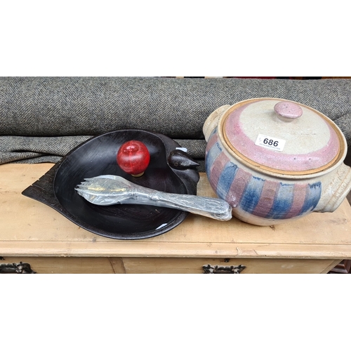 1363 - Ceramic pot with lid, featuring blue and pink stripes. Accompanied by a dark wood bowl and apple orn... 