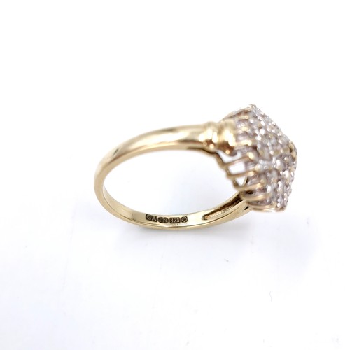 1 - Star Lot : A nine carat gold diamond cluster ring. Est. weight of diamonds - 0.40 carats. Size - N. ... 