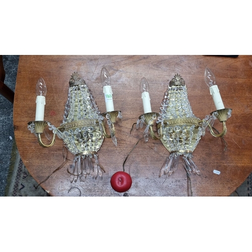 1203 - Star Lot : A super Pair of French basket  crystal wall sconces with brass details, featuring an eleg... 