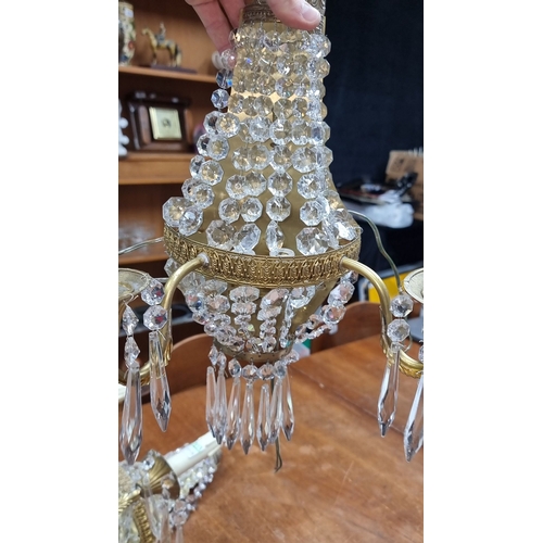 1203 - Star Lot : A super Pair of French basket  crystal wall sconces with brass details, featuring an eleg... 