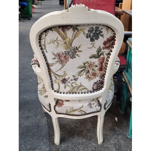 1205 - French-style upholstered armchair with floral tapestry and carved wood frame. Features pastel tones ... 