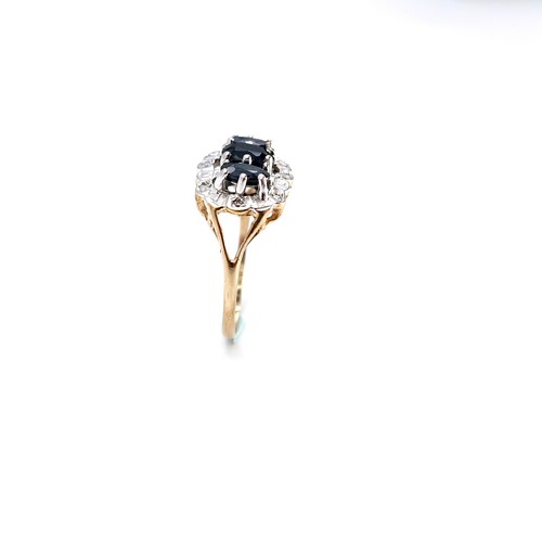 2 - Star Lot : A nice example of a nine carat gold three stone sapphire ring with diamond cluster surrou... 