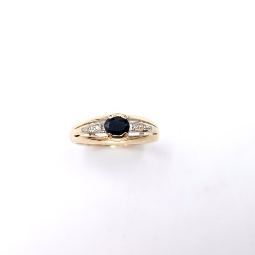 3 - A nine carat gold sapphire stone ring with diamond set shoulders. Size - N. Weight - 2.79 grams.