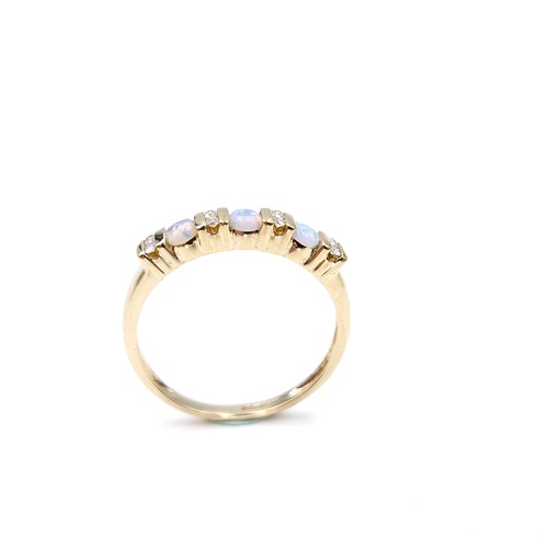 4 - Star Lot : A nine carat gold opal and diamond set ring. Size - S. Weight - 1.86 grams.