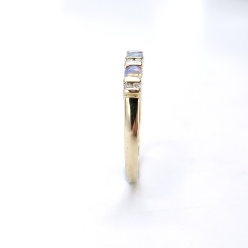 4 - Star Lot : A nine carat gold opal and diamond set ring. Size - S. Weight - 1.86 grams.