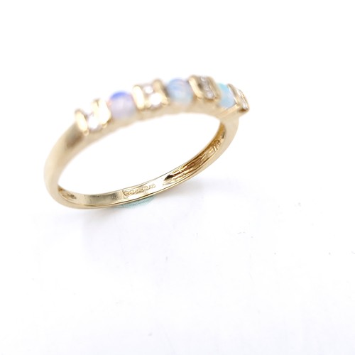 4 - Star Lot : A nine carat gold opal and diamond set ring. Size - S. Weight - 1.86 grams.