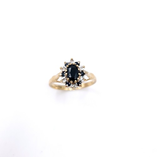 6 - A nine carat gold diamond and sapphire ring. Size - L. Weight - 2.14 grams.