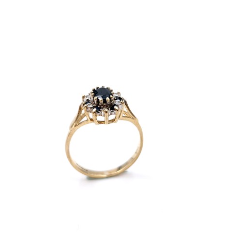 6 - A nine carat gold diamond and sapphire ring. Size - L. Weight - 2.14 grams.