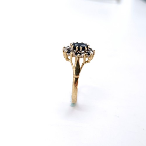 6 - A nine carat gold diamond and sapphire ring. Size - L. Weight - 2.14 grams.