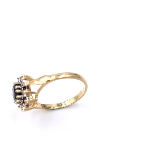 6 - A nine carat gold diamond and sapphire ring. Size - L. Weight - 2.14 grams.